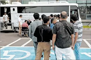  ?? MIN JOO KIM/FOR THE WASHINGTON POST ?? Yemeni refugees, in line for a free health screening by the Korean Red Cross last week on Jeju Island, are stranded there.