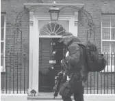  ?? KIRSTY WIGGLESWOR­TH/AP ?? Police are looking into whether Prime Minister Boris Johnson violated COVID-19 lockdown rules. Above, an officer outside 10 Downing Street on Tuesday.