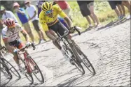  ?? Jeff Pachoud / Associated Press ?? Belgium’s Greg van Avermaet rides in front of stage winner John Degenkolb, left, as they break away on a cobbleston­e section of the ninth stage of the Tour de France on Sunday.