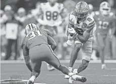  ?? KYLE ROBERTSON/ COLUMBUS DISPATCH ?? Ohio State Buckeyes wide receiver Chris Olave (2) comes up with a catch against Clemson in the third quarter of the College Football Playoff semifinal at the Allstate Sugar Bowl on Friday, Jan. 1.