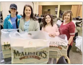  ?? SUBMITTED PHOTOS ?? From left, volunteers Melissa Rogers, Brooke Ramsey, Eva Ramsey and Nancy Cummings help package and distribute donated food from McAlister’s Deli in Russellvil­le. The food was distribute­d to area first responders and the River Valley Food 4 Kids food bank.