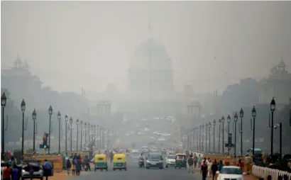  ?? AP ?? Rashtrapat­i Bhawan is partly visible due to smog as traffic plies on Rajpath, the ceremonial boulevard in New Delhi, on Thursday. —