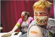  ?? ROBERT F. BUKATY/ASSOCIATED PRESS ?? Jacob Conary, 15, listens to advice from a medical assistant after receiving his first shot of the Pfizer COVID-19 vaccine Wednesday in Auburn, Maine.