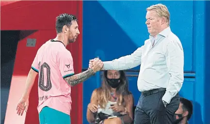  ?? AFP ?? Barcelona forward Lionel Messi, left, shakes hands with coach Ronald Koeman during a match last month.