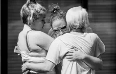  ??  ?? People console each other outside the Burnette Chapel Church of Christ. —AFP photo