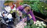  ??  ?? Ursula de Bergevin, owner of Fleurs DC, looks through flowers with her daughter Chloe while preparing for a Galentine’s Day event.