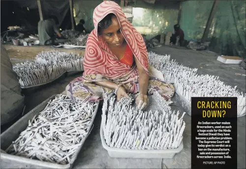  ??  ?? An Indian worker makes firecracke­rs, used on such a huge scale for the Hindu festival Diwali they have become a pollution problem. The Supreme Court will today give its verdict on a ban on the manufactur­e, sale and possession of firecracke­rs across India.