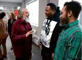  ?? JONATHAN WIGGS/GLOBE STAFF ?? Byron Rushing (left) with Rob “ProBlak” Gibbs and Damon Butler, former Lenox residents who created art for the site.