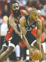  ?? AP/ERIC CHRISTIAN SMITH ?? Milwaukee Bucks forward Khris Middleton (right) looks to pass as Houston Rockets guard James Harden defends during the first half Thursday’s game in Houston.