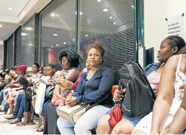  ?? /The Times ?? High hopes: Parents queue at the Gauteng education department in a bid to secure school placements for their children. An increasing population and a shortage of classrooms means thousands of children are left out of the system.