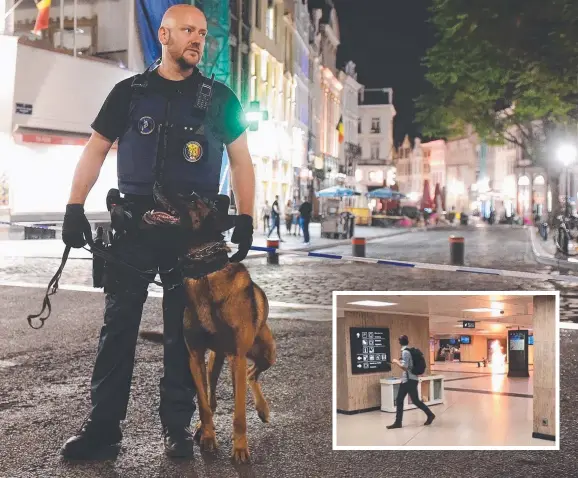  ??  ?? VIGILANT: Armed police stand guard outside Brussels Central train station after a man triggered a small explosion ( inset) inside the station.