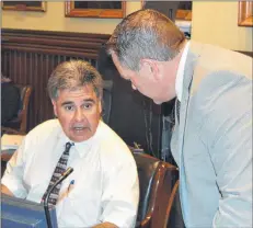  ??  ?? Coun. Mitchell Tweel, chairman of parks and recreation, confers with Coun. Bob Doiron prior to council’s regular public monthly meeting on Monday. Council decided to delay constructi­ng a floating dock at Victoria Park until at least next spring.
