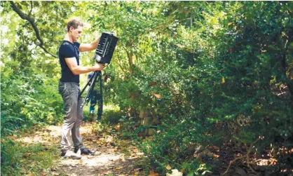  ??  ?? SMART TRAP. In this photo provided by Microsoft, Microsoft researcher Ethan Jackson sets up a trap for mosquitoes in Harris County, Texas in 2016. A new hightech version trap is promising to catch the bloodsucke­rs while letting friendlier insects...
