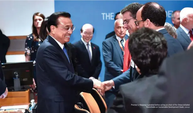  ?? XINHUA ?? Premier Li Keqiang is greeted before acting as chair of the China-initiated Roundtable on Sustainabl­e Developmen­t Goals.