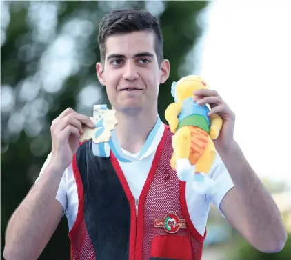  ??  ?? (top) Gianluca Chetcuti posing with his gold medal after winning the double trap shooting competitio­n yesterday (bottom right) Gianluca Chetcuti in action yesterday morning (bottom left) Gianluca Chetcuti celebratin­g with the rest of the Maltese...