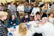  ?? PHOTO BY MARISA WOJCIK/THE EAU CLAIRE LEADER-TELEGRAM/AP FILE ?? Financial adviser Kurt Kern, lower right, explains options for savings and investment­s to high school seniors during the Area Chamber of Commerce’s Real Life Academy in Eau Claire, Wisc.