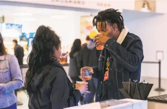  ?? Kassidy Iwashita / Golden State Warriors ?? Top: The Chase Center’s wine program was a priority of Nicole Lacob, wife of Warriors owner Joe Lacob, and features plenty of California wines. Above: Two people taste at the arena.