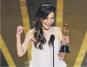  ?? Myung J. Chun Los Angeles Times ?? MICHELLE YEOH accepts the lead actress Oscar on Sunday night for her work in “Everything Everywhere All at Once.”
