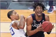  ?? Kathy Willens / Associated Press ?? UConn forward Isaiah Whaley (5) reacts as Seton Hall guard Shavar Reynolds (33) collides with him during the second half of an NCAA basketball game on Wednesday in Newark, N.J.