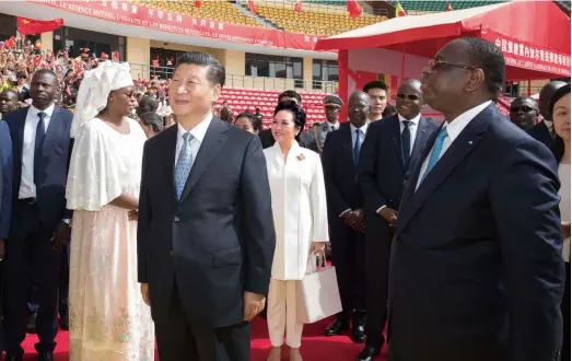  ??  ?? Chinese President Xi Jinping joins his Senegalese counterpar­t Macky Sall at a handover ceremony of the National Wrestling Arena built with Chinese aid in Dakar on July 22