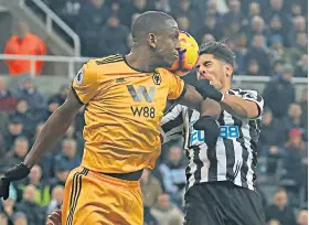  ??  ?? No punishment: Willy Boly appeared to elbow Ayoze Perez in the penalty area