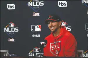  ?? The Associated Press ?? PREPPED FOR GAMEDAY: St. Louis Cardinals starting pitcher Adam Wainwright smiles as he answers a question during a news conference at the National League Division Series Saturday in St. Louis. Wainwright is expected to start when the Cardinals play Game 3 of the series against the Atlanta Braves on Sunday in St. Louis.