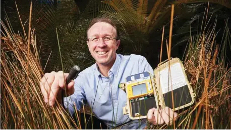  ??  ?? Zoologist Kyle Armstrong holds a bat detector, which helps him identify bat species in northern Australia and PNG from their echolocati­on calls.