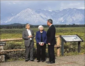  ?? MARTIN CRUTSINGER / AP ?? Federal Reserve Chair Janet Yellen talks with Mario Draghi (right), head of the European Central Bank, and Haruhiko Kuroda, head of the Bank of Japan, during a break at the central bankers conference at Jackson Hole, Wyo., on Friday. The conference, in...