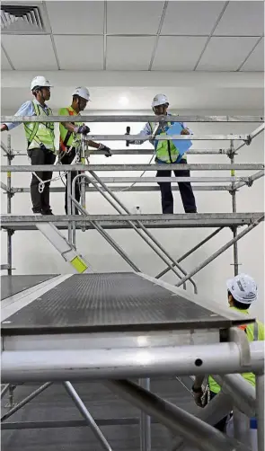  ??  ?? The high point: At the centre, trainees learn the finer points of working at height, while standing on properly engineered scaffolds.