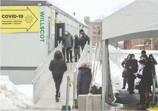  ?? RYAN REMIORZ / THE CANADIAN PRESS ?? People line up to get tested at a COVID-19 clinic this week in Montreal. There is growing skepticism that a third wave is inevitable for Canada.