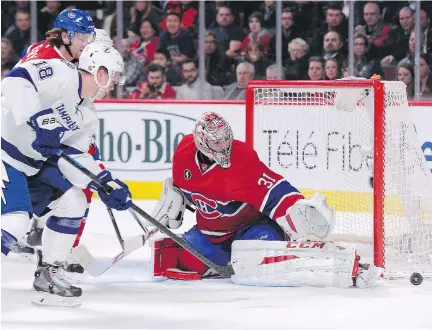  ?? R I C H A R D WO L O WI C Z / G E T T Y I MAG E S ?? Carey Price makes a save with Ondrej Palat of the Tampa Bay Lightning on his doorstep during their game at the Bell Centre, Tuesday. Price kept the highest scoring team in the league goalless during regulation play.