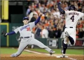  ?? MATT SLOCUM — THE ASSOCIATED PRESS ?? Houston Astros’ George Springer beats Los Angeles Dodgers’ Cody Bellinger to first base during the sixth inning of Game 3 of baseball’s World Series Friday in Houston.