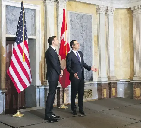  ?? ALEX PANETTA/THE CANADIAN PRESS ?? United States Treasury Secretary Steven Mnuchin, right, welcomes Finance Minister Bill Morneau to the U.S. Treasury Department in Washington on Wednesday. Morneau expressed curiosity about the direction of the U.S. tax plan under Donald Trump.