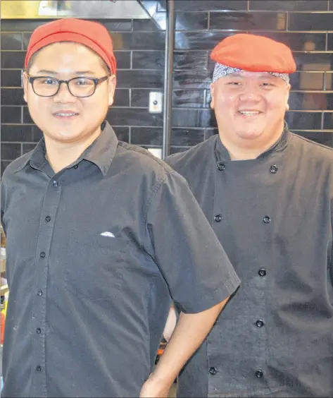  ?? DAVE STEWART/THE GUARDIAN ?? Andy Li, left, and Edward Chan at Mad Wok on Queen Street in Charlottet­own pose for a photo during a busy lunch time earlier this week. The restrauran­t’s owners said two years ago when they opened the plan was to expand to more locations on P.E.I. They plan on opening a second location in Charlottet­own in November at Belvedere Plaza.