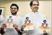  ??  ?? Shiv Sena President Uddhav Thackeray along with Yuva Sena chief Aditya Thackeray release the manifesto for assembly elections in Mumbai, on Saturday