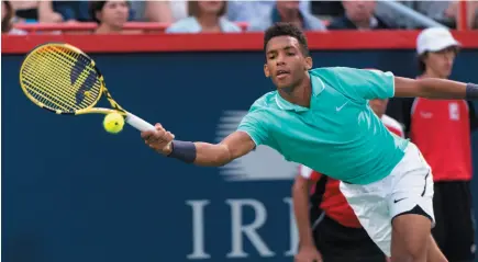  ?? CP PHOTO ?? Felix Auger-Aliassime of Canada returns to compatriot Milos Raonic during second round of play at the Rogers Cup tennis tournament Wednesday in Montreal.