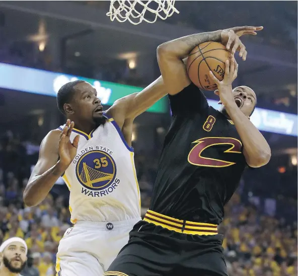  ?? — GETTY IMAGES FILES ?? Kevin Durant, left, of the Golden State Warriors battles Channing Frye of the Cleveland Cavaliers in Game 2 of the NBA Finals Sunday in Oakland. Durant has been dominant for the Warriors, who take a 2-0 lead into Game 3 Wednesday in Cleveland.