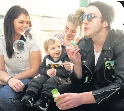  ??  ?? BUBBLES OF JOY Glasvegas singer James has a laugh with, from left, Donna, Kiera and her son Jackson at the Quarriers family resource centre in Ruchazie, Glasgow Picture Mark Anderson