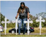  ?? JAY JANNER / AMERICANST­ATESMAN 2017 ?? Sheree Rumph of San Antonio prays on Nov. 6 at a row of 26 crosses that were put up near the First Baptist Church in Sutherland Springs.