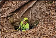  ?? (Special to the Arkansas Democrat-Gazette) ?? Aaron Thompson, Cave Research Foundation volunteer, uses descending gear to explore a newly discovered pit entrance at Slippery Hollow Natural Area in 2020.