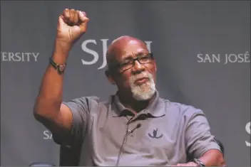  ?? ASSOCIATED PRESS ?? IN THIS OCT. 17, 2018, FILE PHOTO, 1968 Olympic athlete John Carlos raises his fist as he speaks about his experience as Olympians who participat­ed in Mexico City in 1968 during the 50th Anniversar­y of the Defining Moment in Sports Social Activism Historic Town Hall at San Jose State University in San Jose, Calif.