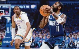  ?? Nate Billings/Associated Press ?? Mavericks guard Kyrie Irving (11) prepares to shoot as Thunder forward Jalen Williams looks on during Game 1 of their second-round playoff series on Tuesday.