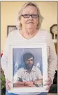  ?? SERGIO FLORES THE NEW YORK TIMES ?? Donna Boatright holds a photograph of her late husband Benny in her home in Abilene, Texas, earlier this month.