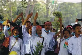  ?? THE ASSOCIATED PRESS ?? Anti-coup protesters flash the three-fingered salute outside the Hledan Centre in Yangon, Myanmar Monday. Protesters gathered in Myanmar’s biggest city Monday despite the ruling junta’s thinly veiled threat to use lethal force if people answered a call for a general strike opposing the military takeover three weeks ago.