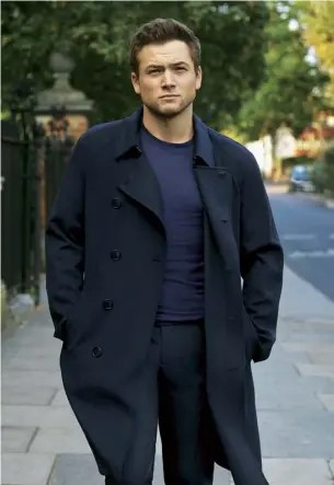  ??  ?? Egerton wears: trench coat, £2,000, sweater, £860, and chinos, £630, all Giorgio Armani (armani.com)