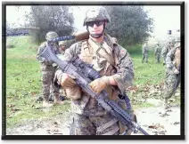  ?? Courtesy photo ?? Below: David stands with his SAW machine gun, something he had “lugged around” for six months during training.