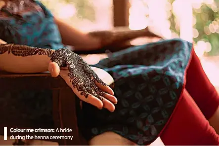  ??  ?? SUMIT PATIL Colour me crimson: A bride during the henna ceremony