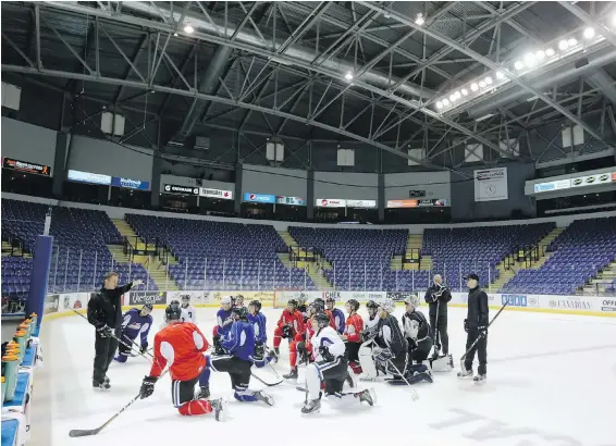  ??  ?? Victoria Royals players listen to coach Dan Price during a practice at Save-on-Foods Memorial Centre.