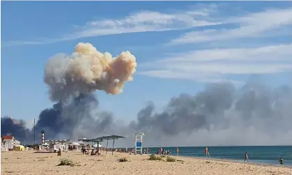  ?? Photograph: AP ?? Rising smoke can be seen from the beach at Saky, in Crimea, after explosions were heard on 9 August.