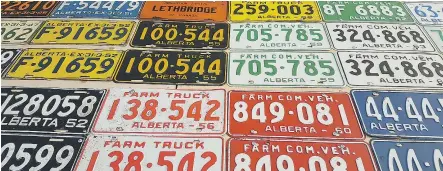  ??  ?? A very small sample of Jason Kinderwate­r’s incredible Alberta licence plate collection.